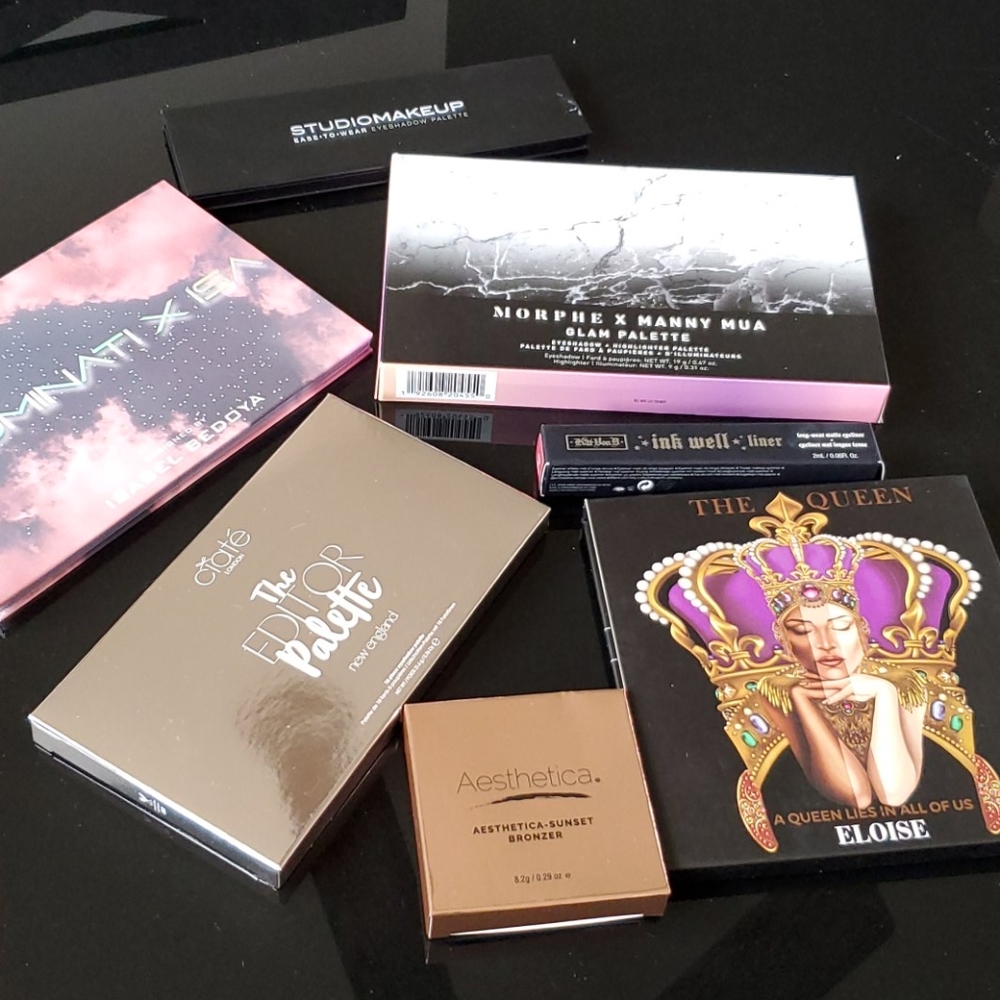 Five eyeshadow palettes, a bronzer, KVD eyeliner